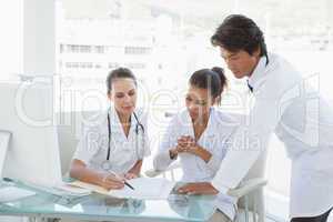 Doctors reviewing notes together