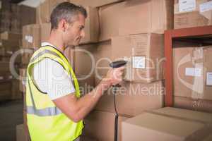 Worker scanning package in warehouse