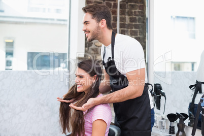 Handsome hair stylist with client