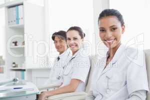 Smiling doctors sitting beside each other