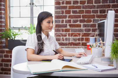 Casual designer working at her desk