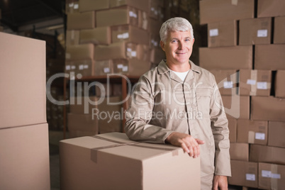 Confident worker smiling in warehouse