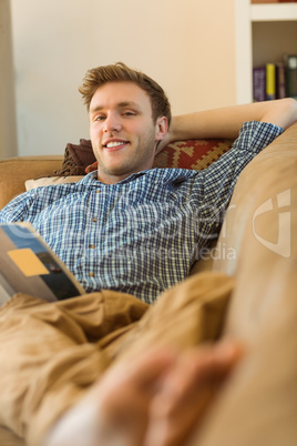 Young man reading on his couch