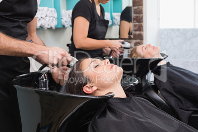 Hairdressers washing their clients hair