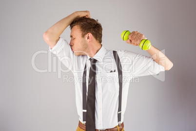 Geeky businessman lifting a dumbbell