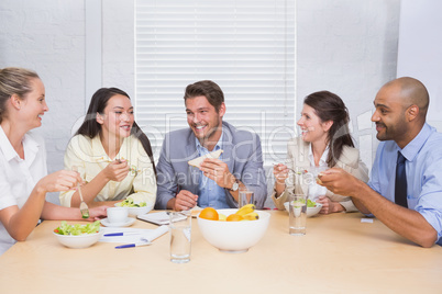 Workers laughing while enjoying lunch break