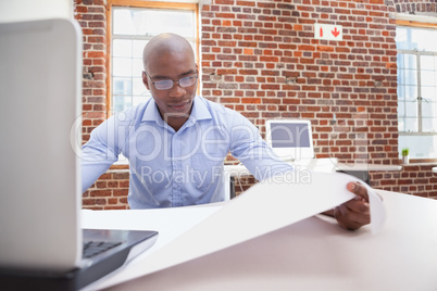 Casual businessman using his laptop at desk