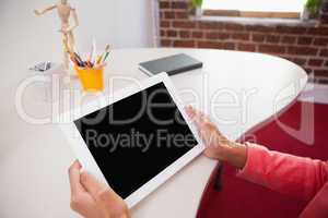 Casual businesswoman using tablet pc