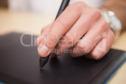 Male hand drawing on graphics tablet