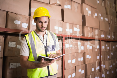 Worker with diary in warehouse