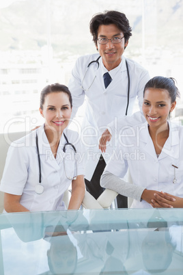 Smiling doctors looking at camera