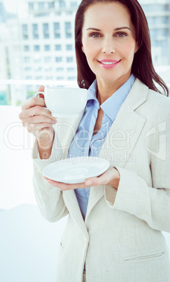 Smiling businesswoman holding a drink