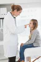 Smiling doctor touching patients nose