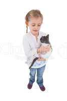 Pretty little girl with her cute kitten