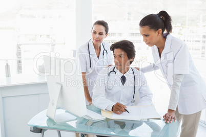 Doctors looking at a computer