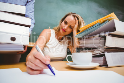 Beautiful businesswoman writing document at desk