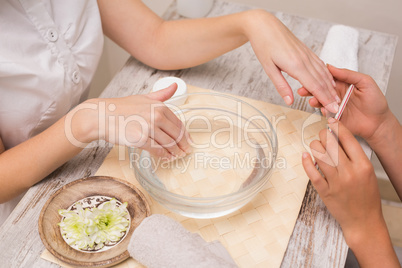 Nail technician giving customer a manicure