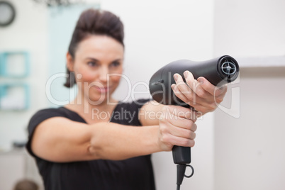 Hairdresser smiling and holding hairdryer