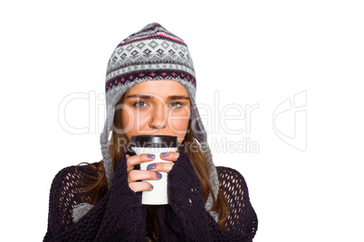 Beautiful woman in warm clothing drinking coffee