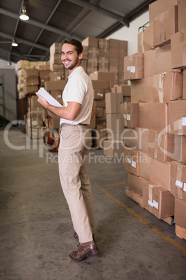 Portrait of warehouse worker with clipboard