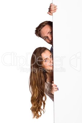 Portrait of young couple with blank board