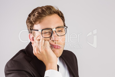 Young geeky businessman looking bored