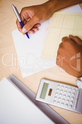 Hand writing documents at desk