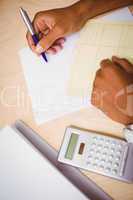 Hand writing documents at desk