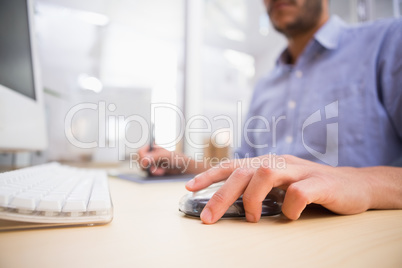 mid section of man working on computer and digitizer