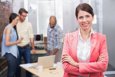 Businesswoman smiling at camera with arms crossed