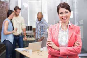 Businesswoman smiling at camera with arms crossed