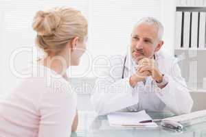 Patient consulting a happy doctor