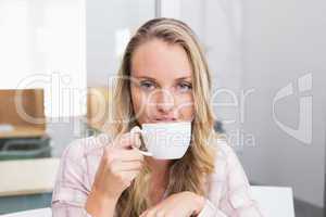 Businesswoman holding coffee mug and smiling