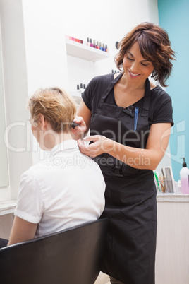 Hairdresser styling customers hair