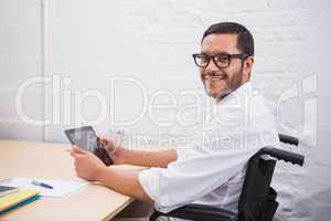 Businessman using digital tablet at desk