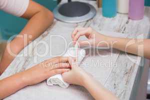 Nail technician giving manicure to customer