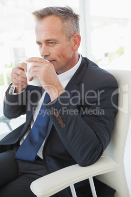 A businessman enjoying his drink