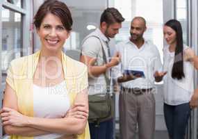 Smiling businesswoman posing with arms folded