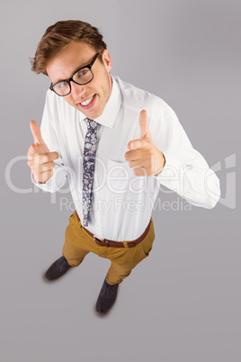 Young geeky businessman showing thumbs up
