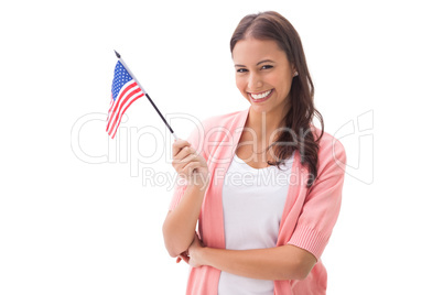 Pretty brunette smiling and holding american flag