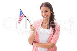 Pretty brunette smiling and holding american flag