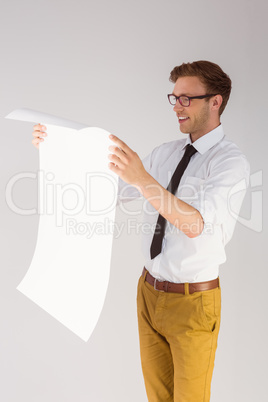 Geeky businessman reading large page