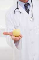 Doctor holding an apple in his hand