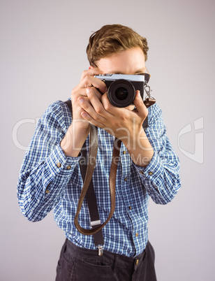 Geeky hipster holding a retro camera