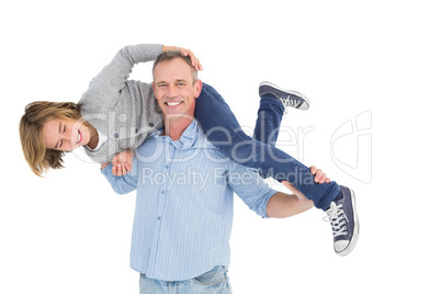 Smiling man carrying son on his shoulders