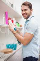 Smiling hairdresser with hair products