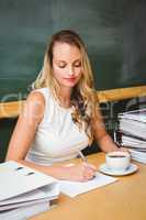 Beautiful businesswoman writing document at desk