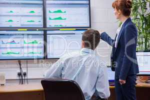 Focused colleagues analyzing result on their computer