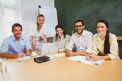 Casual business team having a meeting using laptop