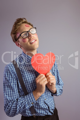 Geeky hipster covered in kisses